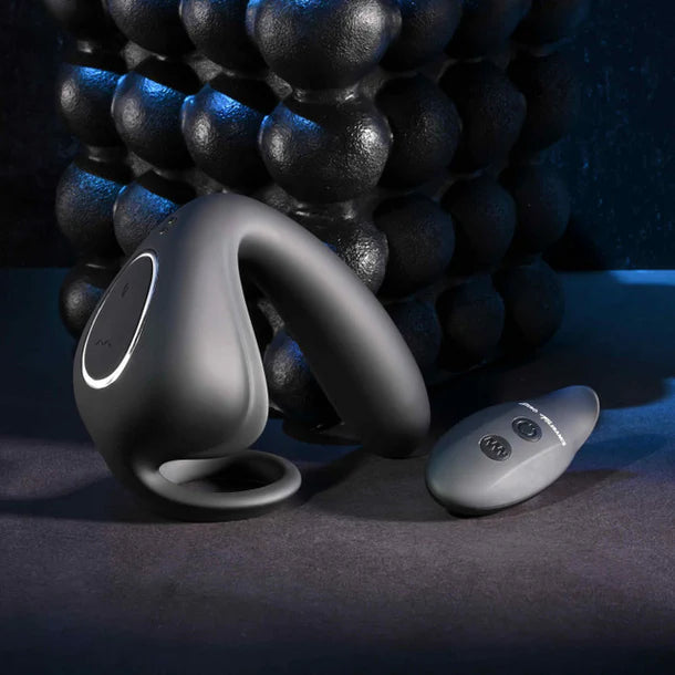 Black Anal plug with cock ring device with remote control on a dark background