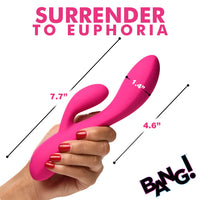 pink silicone rabbit vibrator with messurments, held in hand on a white background