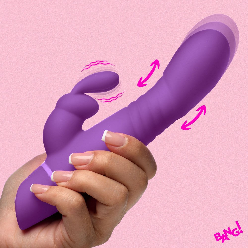 Purple vibrator held in a hand with pink arrows and 'BANG!' text on a pink background