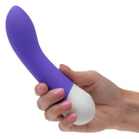 Purple and white g spot vibrator held in a hand with pink nail polish on a white background
