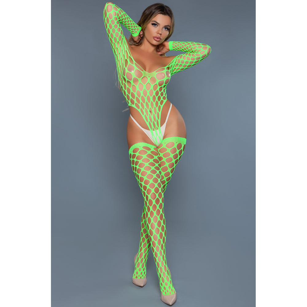 Model wearing a neon green fishnet bodysuit against a gray background