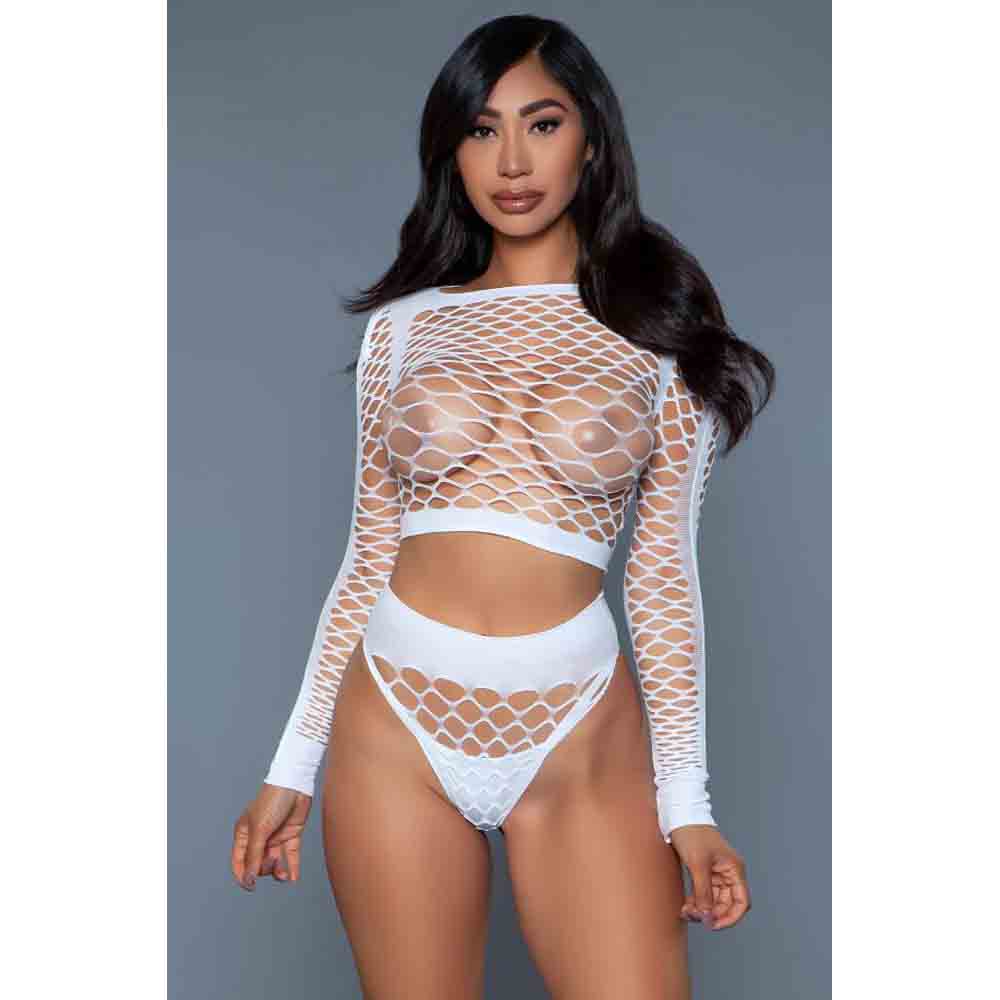 A model wearing a white long sleeve top and matching bottoms with a fishnet design.