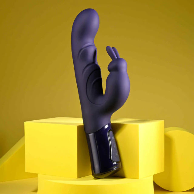 Purple abstract vibrator on a yellow geometric platform with a yellow background