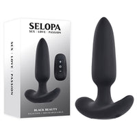 black tapered butt plug with rounded out bottom base beside display box