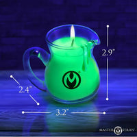 Glowing green candle in a glass pitcher with measurements and 'Master Series' branding.