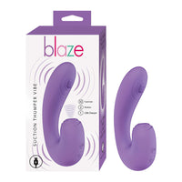 curved vibrator with thumper action on top center, with clitoral suction in purple beside box packaging