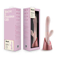 Pink and white vibrator with packaging labeled 'You're a Precious Gift' on a white background