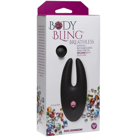 A white box with multicolored jewels on it that depicts a black crab claw shaped toy with a pink jewel function button