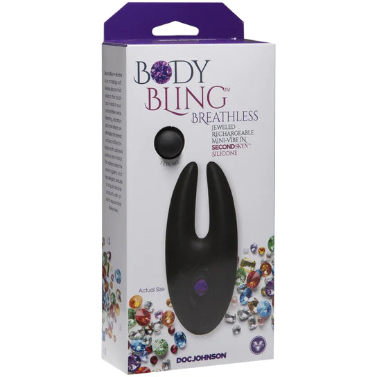 A white box with multicolored jewels on it that depicts a black crab claw shaped toy with a purple jewel function button