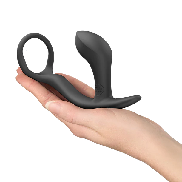 Black silicone prostate massager held in a hand on a white background