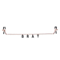 chained nipple clamps with the word brat hanging below