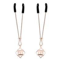 tweezer style nipple clamps in rose gold with dangling enblem