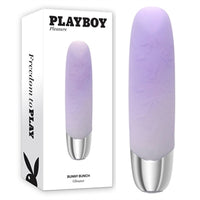 purple sleek vibrator with silver handle standing beside display box