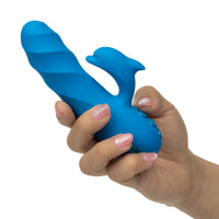 blue swirl vibrator with dolphin stimulator held in hand