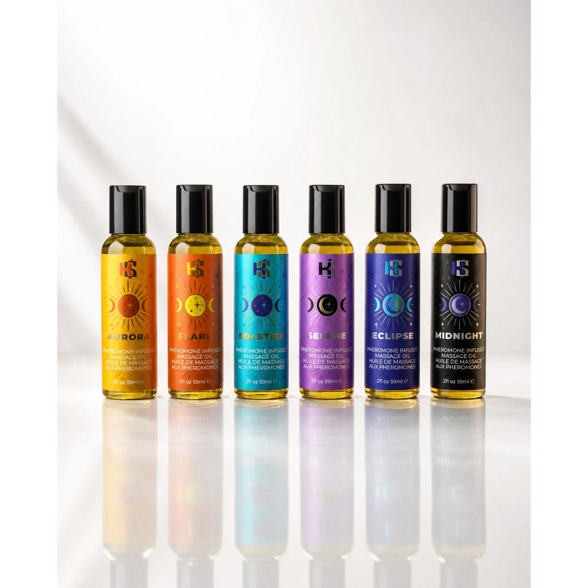 Six small cylindrical bottles with black caps lined up on a glossy white surface. Each bottle has a different colored label in yellow, orange, turquoise, purple, blue, and black, featuring moon phase graphics and the brand logo 'HS'.