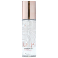 Bottle of personal lubricant with a rose gold cap on a white background