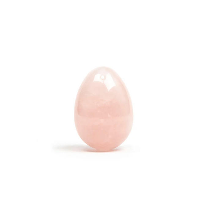 pink yoni egg on white background