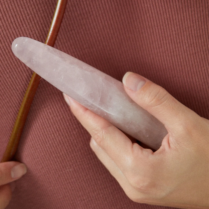 pink marble crystal stone dildo held in hand