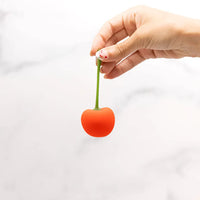 red cherry egg vibrator held by hand