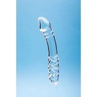A transparent glass dildo with a textured handle, shown vertically against a light blue gradient background.