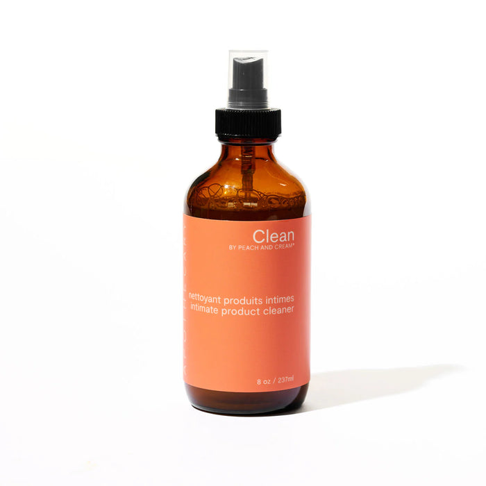 Amber glass bottle with an orange label clean toy cleaner on a white background