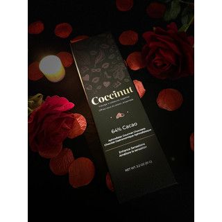 Dark chocolate bar with 'Cocacinol' branding on a dark background with red flowers.