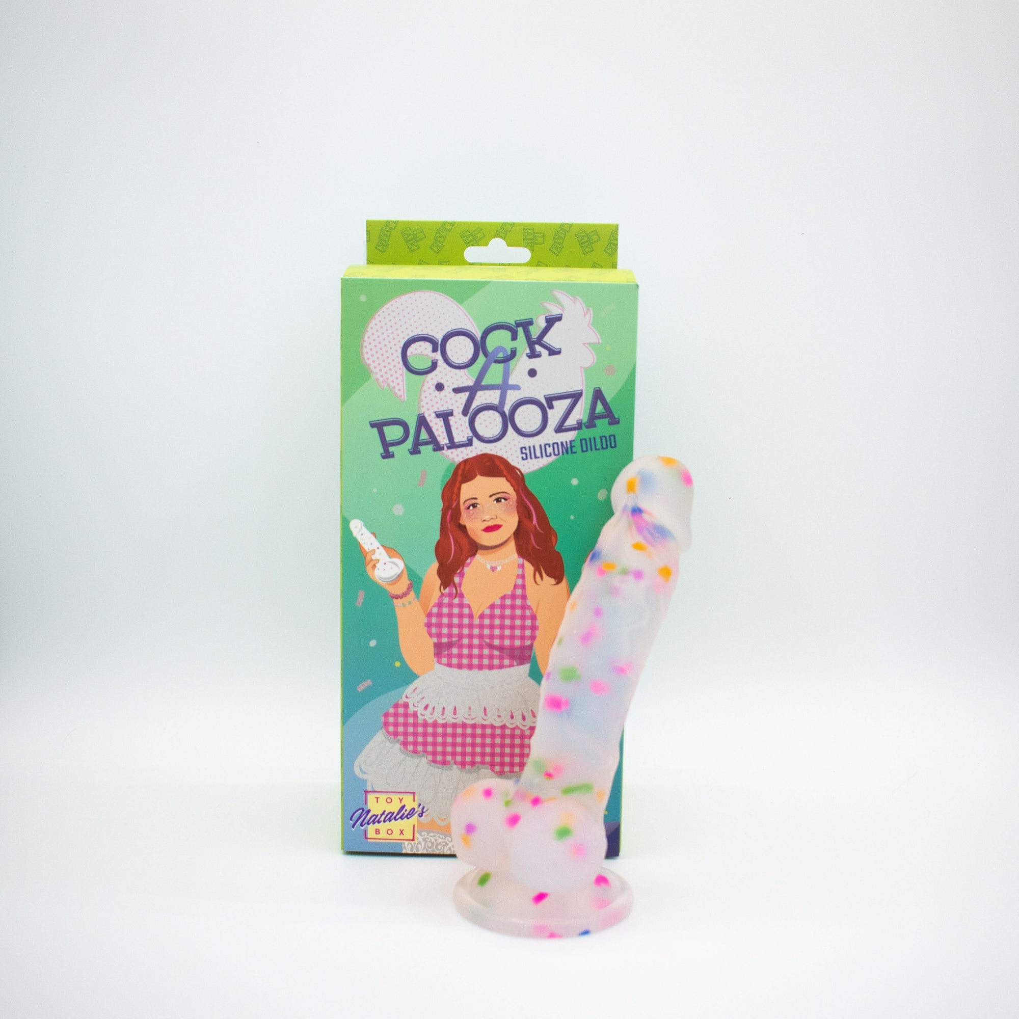 Silicone dildo with colorful sprinkles next to its packaging on a white background