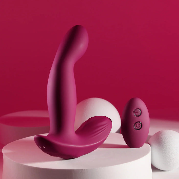Pink and white vibrating anal plug with remote control on a pink background