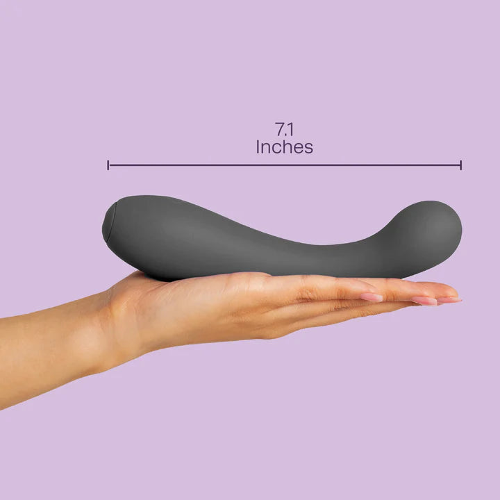 black curved vibrator on hand, with size specs on purple back ground