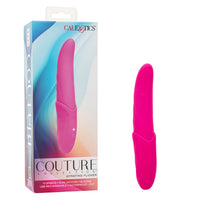 tongue shaped body and top, with wider handle vibrator in pink beside box packaging