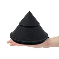 Black cowgirl cone held in a hand on a white background