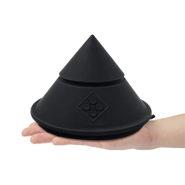 Black cowgirl cone held in a hand on a white background