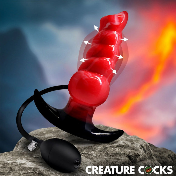 Red and black product on a rock with fiery background, labeled 'Creature Cocks'.