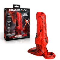 Creature Cocks Hell Hound silicone penis enhancer sleeve by XR Brands in red and black marbled silicone with fantasy-inspired texture and attached support loop, shown alongside themed retail packaging.