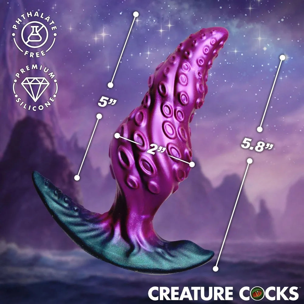 Purple and blue silicone product with measurements against a starry sky background, featuring 'Creature Cocks' branding.
