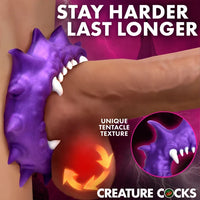 Creature Cocks Constrictor Silicone Cock Ring by XR featuring a purple monster-inspired design with fang and spike details, soft stretchy premium silicone, a 1.1" unstretched inner diameter, and 3.2" overall height