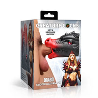 Creature Cocks Drago Silicone Masturbator retail packaging featuring the black and red dragon-shaped stroker with sculpted scales, horns, red eye, open mouth, and textured tongue. Package highlights the soft, squishable material and fantasy dragon design.