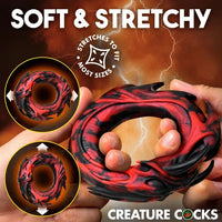 Creature Cocks Hell Fang Silicone Cock Ring by XR featuring a demon-inspired red-and-black design, soft stretchy premium silicone, a 1.1" unstretched inner diameter, and 2.4" overall height.