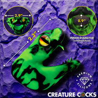 Green silicone product with measurements on a purple textured background, featuring 'Creature Cocks' branding.