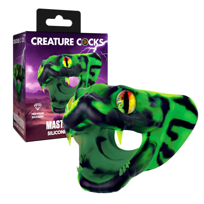 Green silicone snake-shaped product with black accents and colorful eyes, next to its packaging.