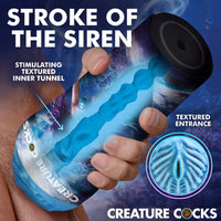 Creature Cocks Maven Mermaid masturbator promotional image showing the blue textured inner tunnel and textured entrance with fantasy-themed packaging artwork.