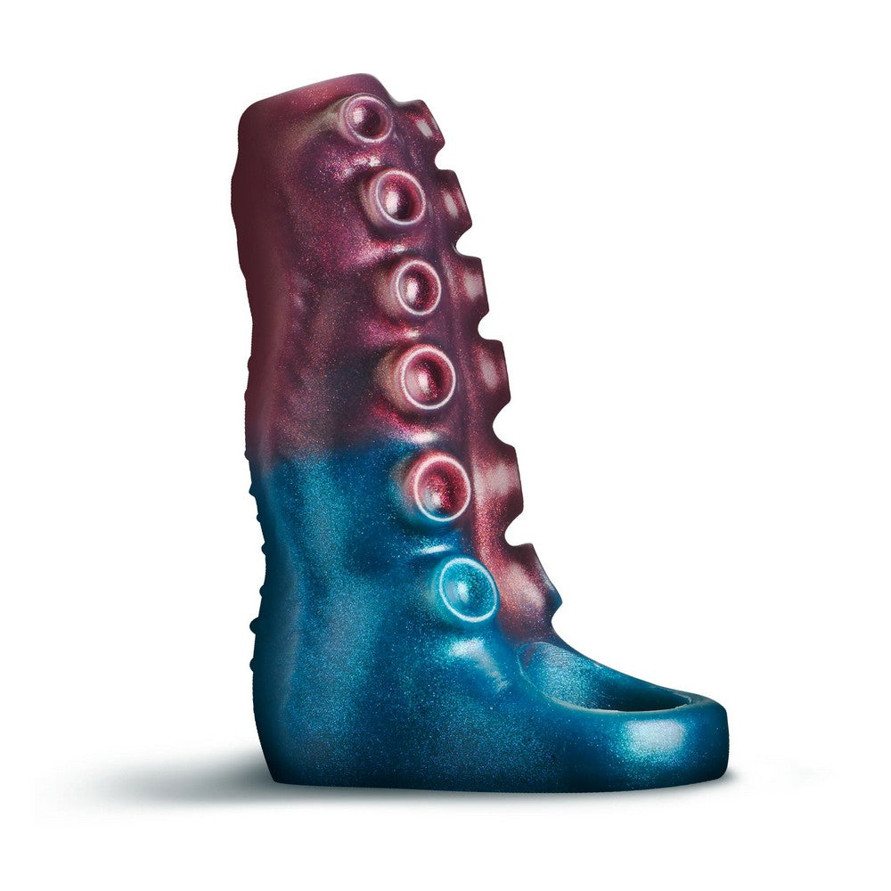 A tentacle shaped penis enhancer with a glossy metallic finish, featuring a gradient from deep teal-blue at the bottom to dark magenta-pink at the top, with six circular protruding details down the side, shown on a white background.