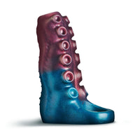 A tentacle shaped penis enhancer with a glossy metallic finish, featuring a gradient from deep teal-blue at the bottom to dark magenta-pink at the top, with six circular protruding details down the side, shown on a white background.