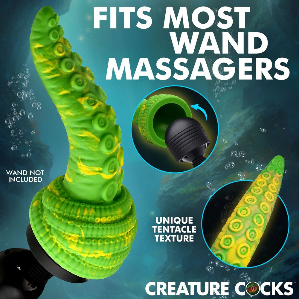 Green tentacle-shaped wand massager with yellow suction cup details, shown against a dark blue underwater-style background with text reading 'FITS MOST WAND MASSAGERS' and 'CREATURE COCKS'. Two circular inset images highlight the interior opening and tentacle texture.