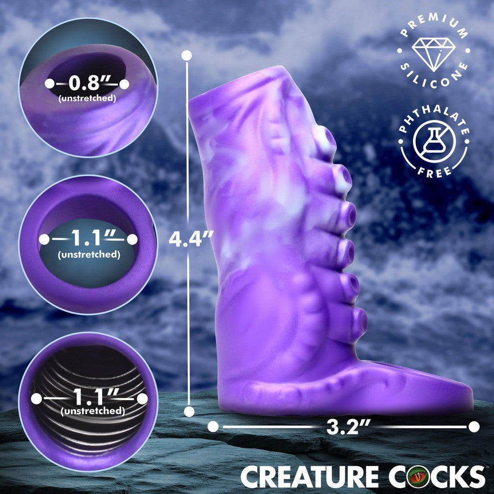 Purple textured silicone adult novelty product shown on a dark blue background with measurement callouts indicating 4.4 inches tall by 3.