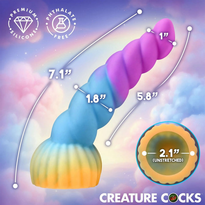 Twisting unicorn-style adult novelty toy with a pastel rainbow gradient and dimension callouts on a dreamy pastel sky background. Text includes 'PREMIUM SILICONE', 'PHthalate FREE', size measurements, and 'CREATURE COCKS'.