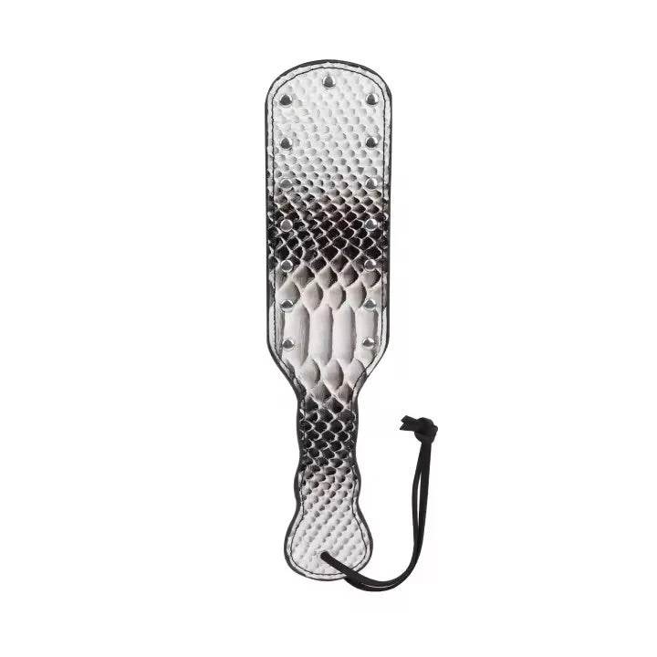 A textured paddle with a snakeskin-patterned design, metal studs, and a black wrist strap, shown on a plain white background.