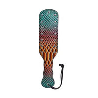 A paddle-style strap-on paddle with a textured reptile-skin pattern featuring a gradient of teal green, purple, orange, and brown, embellished with silver studs and a black wrist strap, shown on a plain white background.