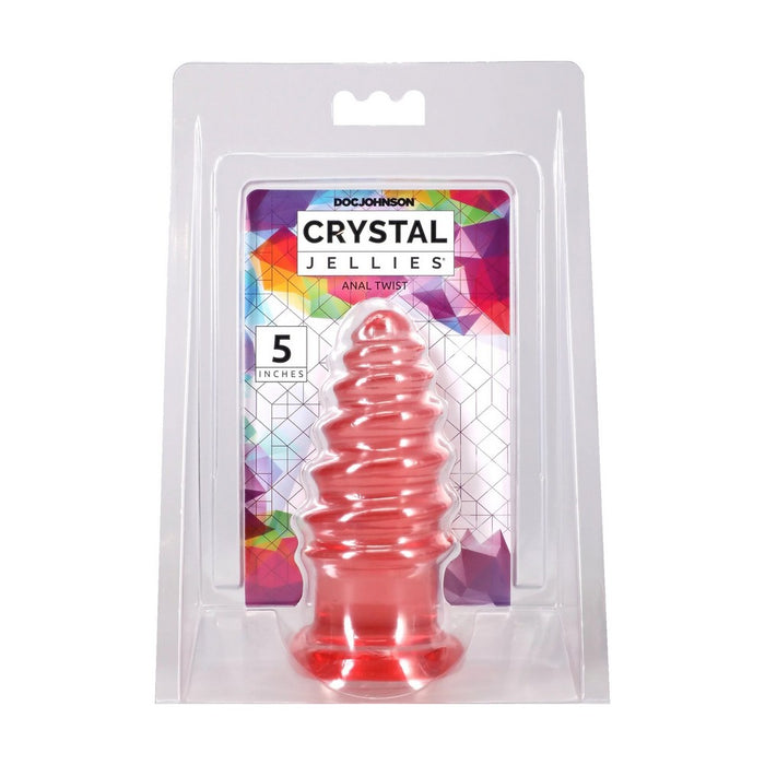 Doc Johnson Crystal Jellies Anal Twist in a clear blister pack with a colorful geometric backing card, showing a translucent pink-red spiral anal plug.