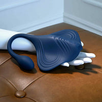 Blue and white handheld massager on a brown leather surface